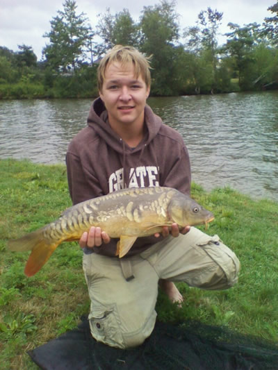 Zach Randlett with a 7 lb, 7 oz mirror carp caught during session 5